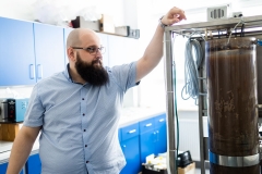 Ofman, PhD, Eng and the SBR-type biological reactor he designed, photo by Paweł Jankowski