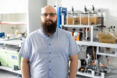 Ofman, PhD, Eng and the SBR-type biological reactor he designed, photo by Paweł Jankowski